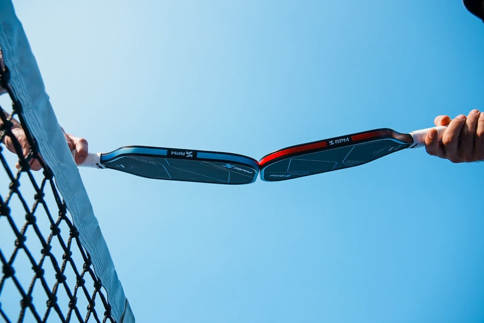 Players tapping RPM paddles at the net